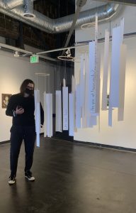 Pierce Johnson stands near gallery interactive in Julia Glatfelter's exhibition, "What Have We Heard?" at the Creative Alliance at the Patterson, April 17-May 29, 2021. Photo: Sandra Abbott